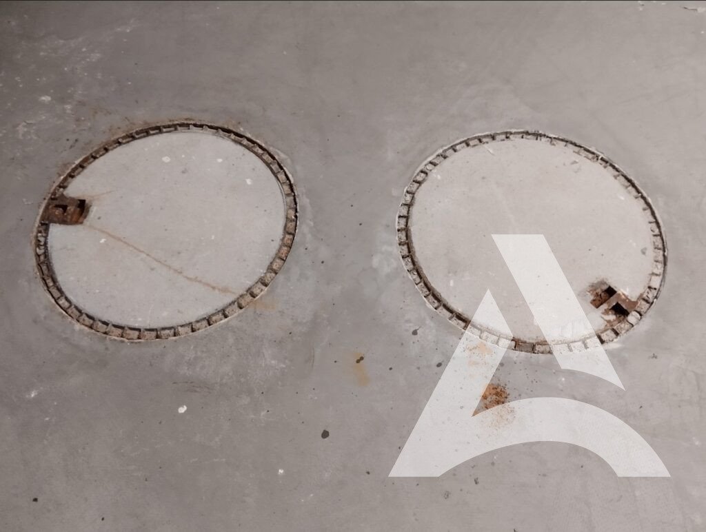 Photo avant entretien de plaques d'égout, rouille sur ciment