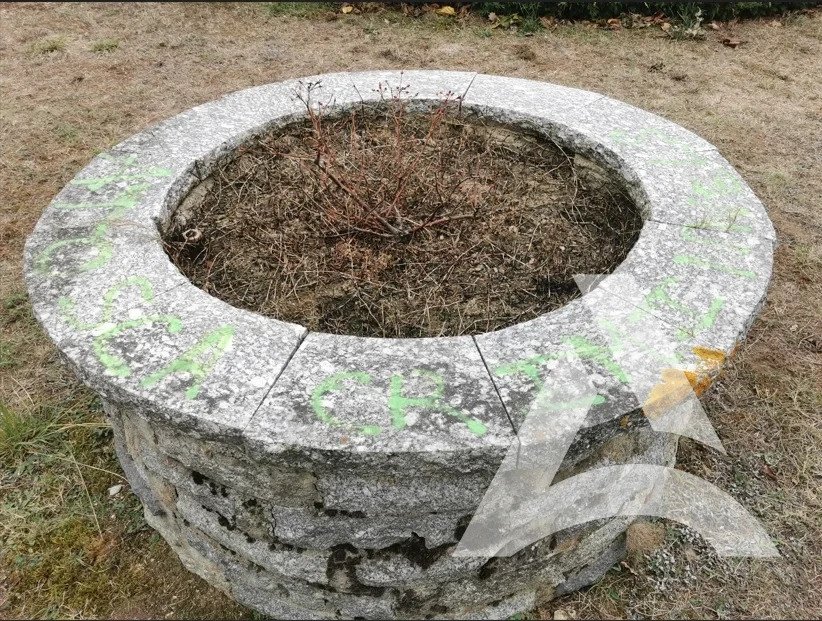Puits en pierre naturelle recouvert de tags verts et jaunes