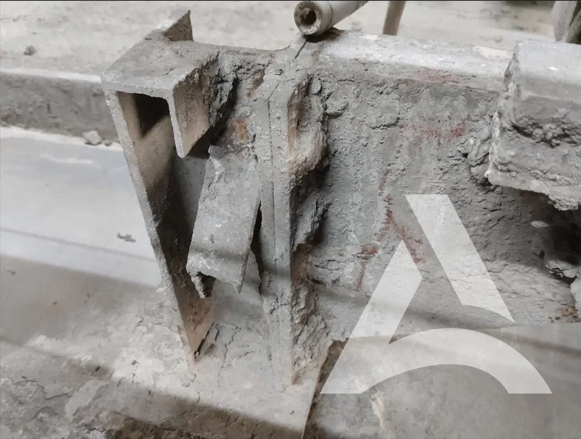 Poutre en acier encrassée par des résidus de colle et de ciment avant nettoyage industriel